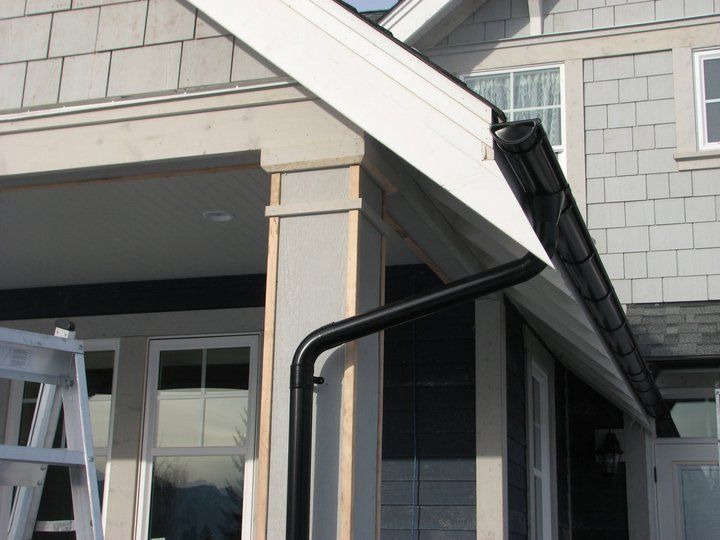 Black Lindab gutter and downpipe